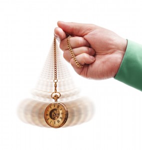 Hypnotism concept, gold pocket watch swinging used in hypnosis treatment