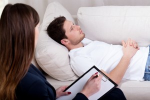 Young therapist working with patient on hypnosis